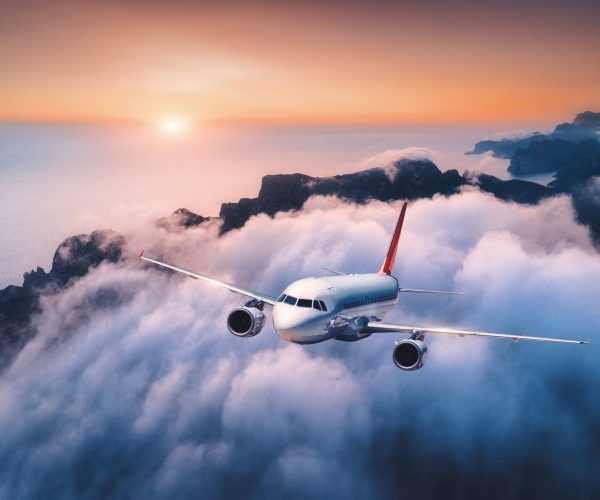 passenger-airplane-is-flying-over-clouds-at-sunset-1.jpg